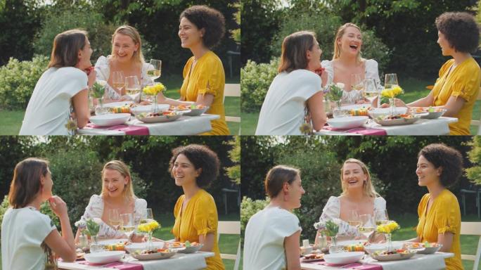 三个女性朋友坐在夏天的花园里吃饭喝酒，一边聊天，一边追赶慢动作