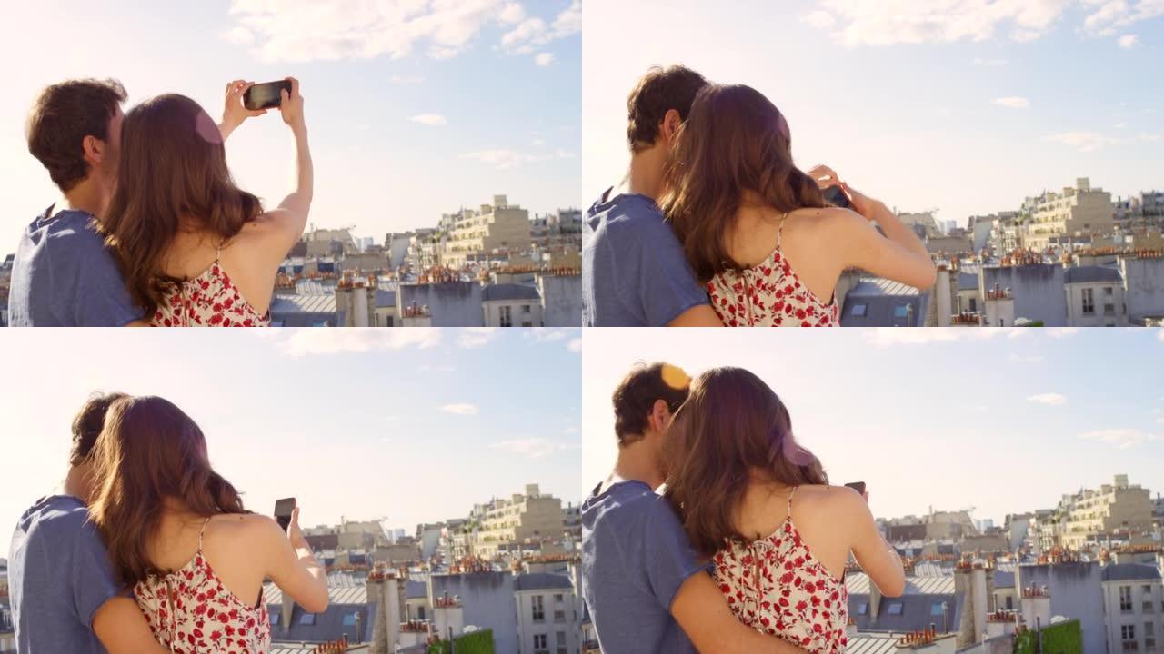 一对年轻夫妇在俯瞰法国巴黎埃菲尔铁塔的公寓阳台上拍照的4k视频片段