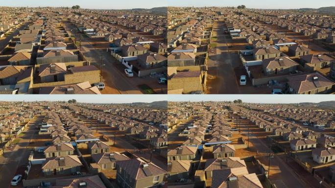 南非一个非洲小镇的低成本住房的空中平移视图，屋顶上有太阳能间歇泉