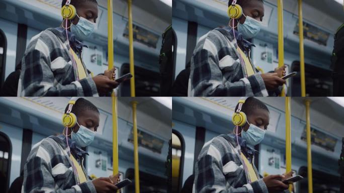 戴着医用口罩的年轻黑人妇女晚上乘地铁回家，用智能手机打字。时尚的女性乘坐公共交通工具旅行，尊重检疫规
