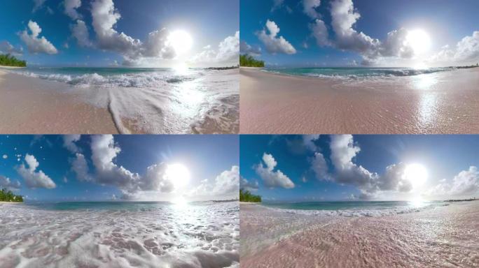 低角度: 小海浪席卷空旷的白沙天堂海滩
