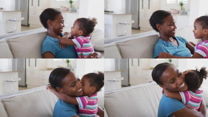 快乐的非洲裔美国母女坐在沙发上拥抱