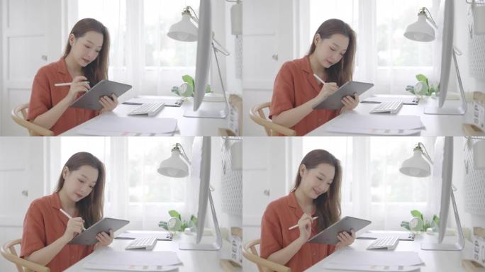 美丽的亚洲女商人年龄36岁在家工作的数字平板电脑与电脑。成人在线学习概念。与阿尔法香奈儿。
