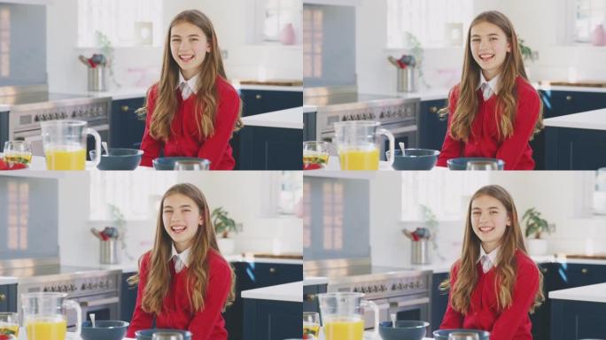 微笑的少女穿着校服在厨房吃健康早餐的肖像