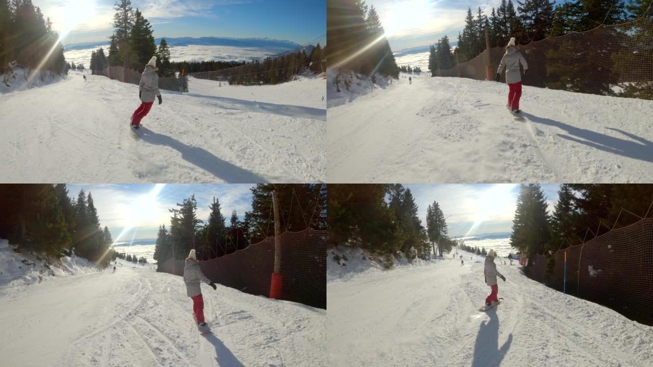 在一个阳光明媚的冬日，年轻女子骑着滑雪板沿着滑雪坡走