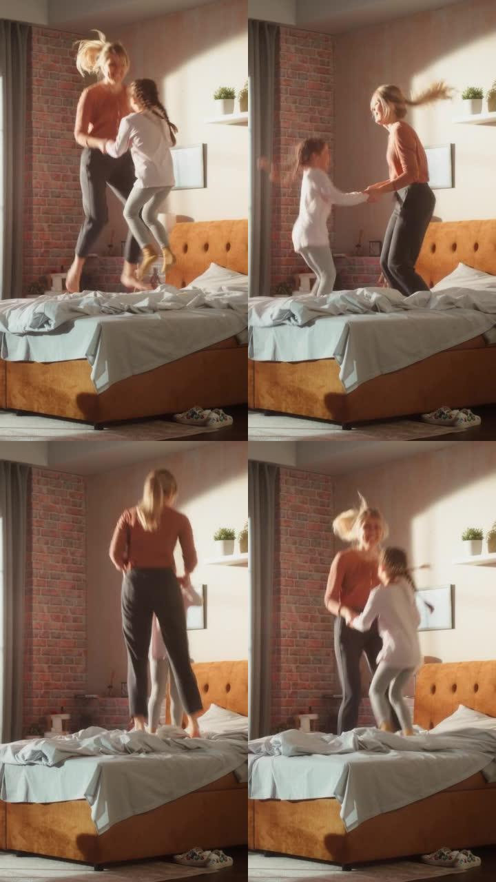 垂直屏幕: 可爱的小女儿和年轻的母亲在家里玩得开心。在家里愉快地玩耍，在时尚的阁楼公寓里跳上床。快乐