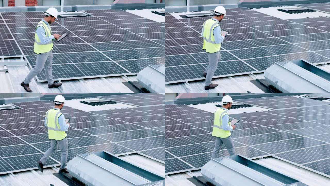电工检查他工作的建筑物屋顶上的太阳能电池板技术。戴着安全帽的专业工程师技术员仔细观察他的现代可再生能