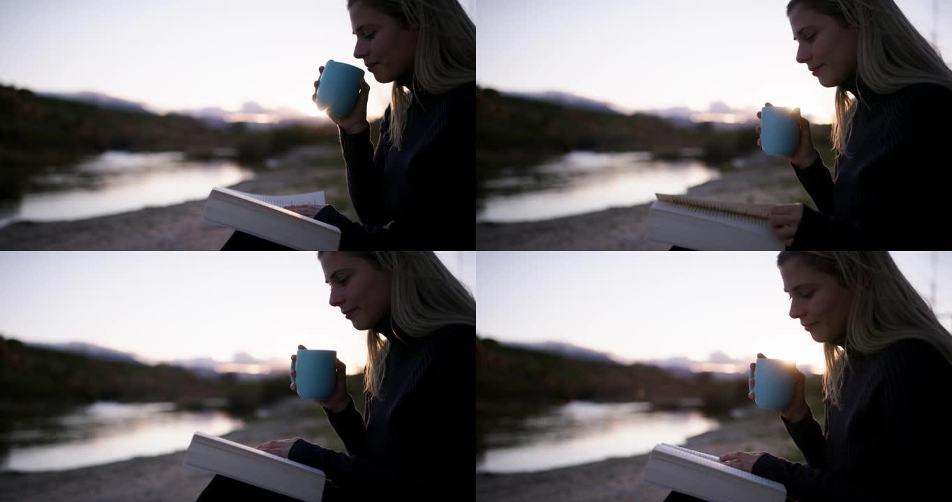 4k视频片段，一名年轻女子在露营旅行中坐着喝咖啡和阅读