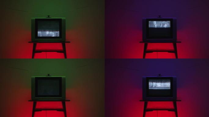 在一个小桌子上的框架中间带有电视静电噪声的旧电视，背景具有红色，紫色和绿色的渐变