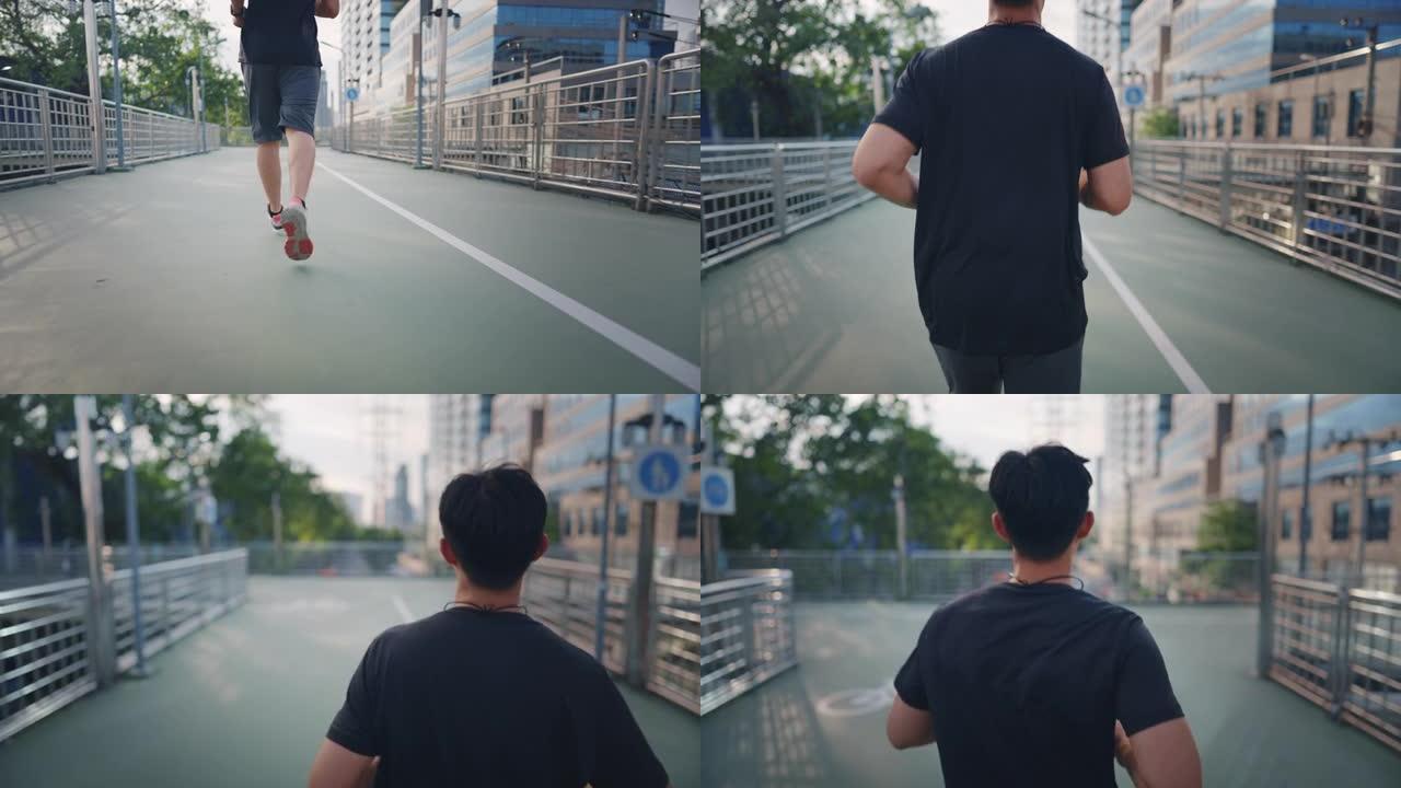 迷人的亚洲成年男子在城市跑步或慢跑。进行运动训练的男性通过在早上进行街头城市跑步来挑战自己。