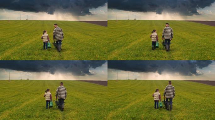 农夫带着他的小儿子走过绿色的田野。慢动作