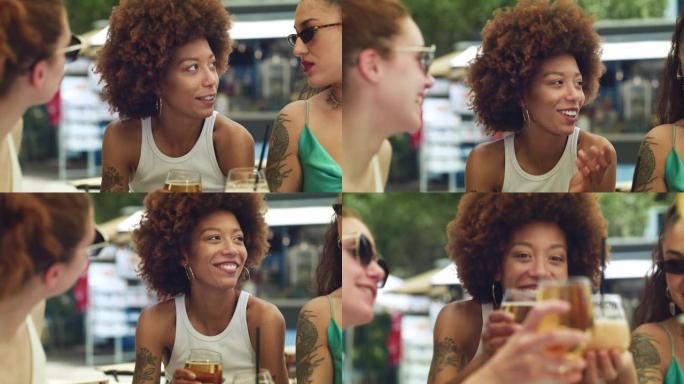 一群多民族妇女在露天酒吧举杯为友谊干杯。不同的女性朋友在夏季旅行中庆祝和欢呼快乐的回忆
