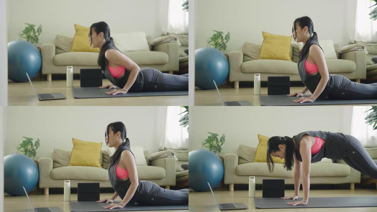亚洲女性在家锻炼。