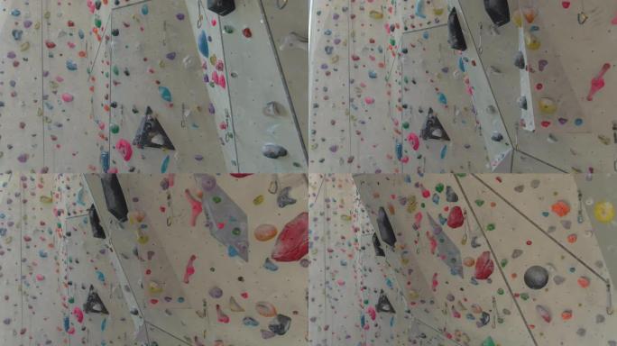 空中: 攀岩馆的墙壁上充满了五颜六色的镁覆盖的支撑。