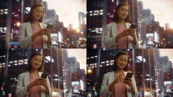 一位自信的日本女性在日落时穿着时髦的休闲服并使用智能手机的肖像。时尚的女人在网上与人联系，传递信息和