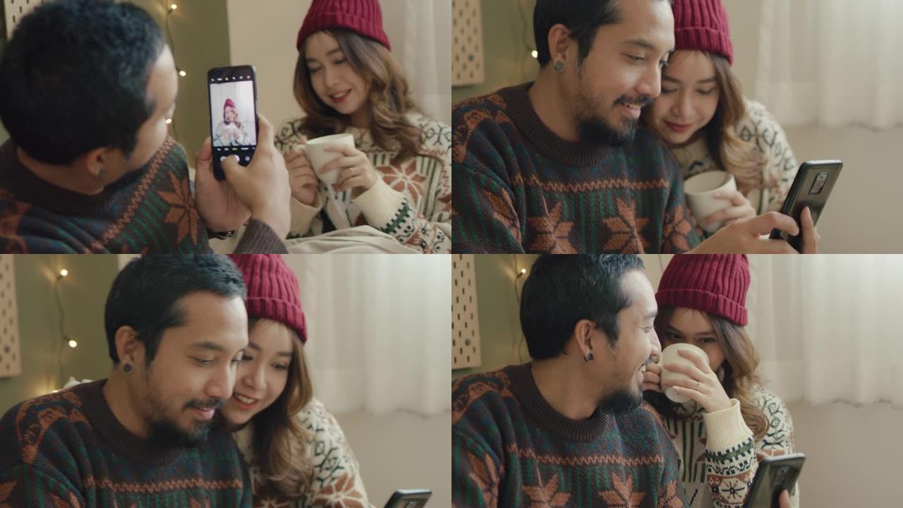 时髦情侣在家使用智能手机自拍摄影。