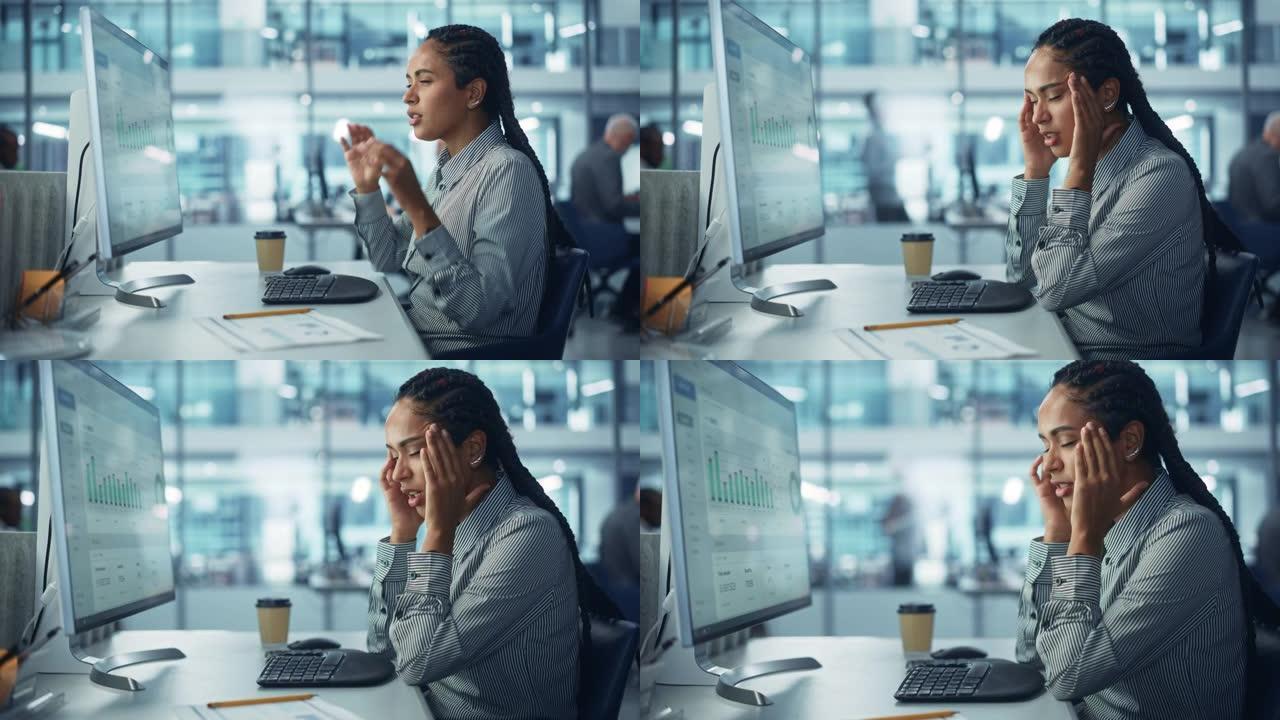 黑人女性公司办公室工作人员感到压力，生病，沮丧，生病在计算机上工作。会计感到项目压力，头痛按摩头部，