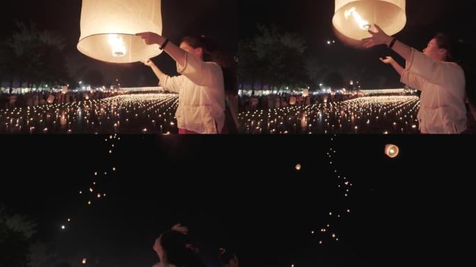 美丽的爱桑年轻女孩在Loi kathong传统节日向天空发射灯笼。