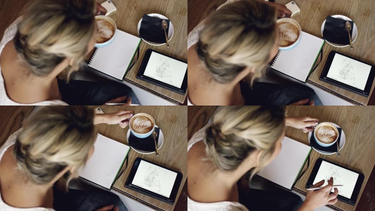 4k视频片段，一个无法识别的女人在咖啡馆喝咖啡时做笔记并使用数字平板电脑