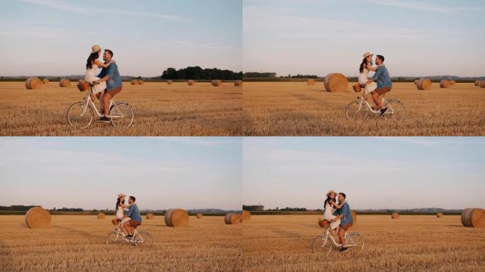 慢镜头中，一对可爱的中年夫妇面对面地骑着自行车经过一片收割过的田地