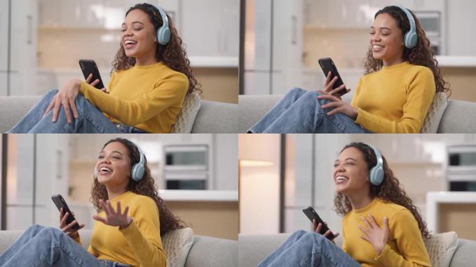一名年轻女子在家中沙发上使用智能手机和耳机的4k视频片段