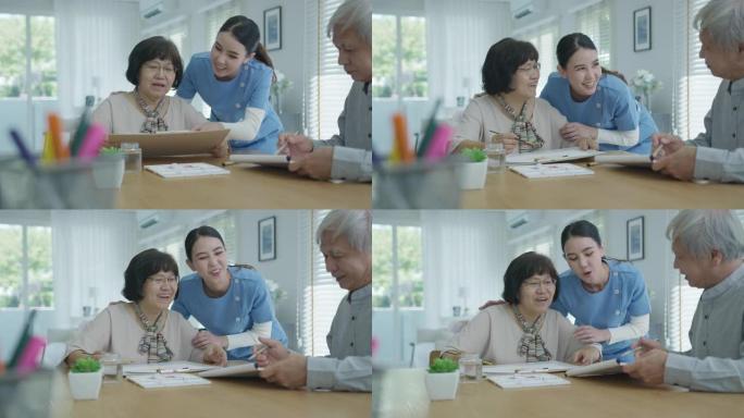 迷人的年轻亚洲公民夫妇坐在家里的水彩画艺术品桌子上，护士在精神卫生治疗或亚洲老年人检疫活动生活方式中
