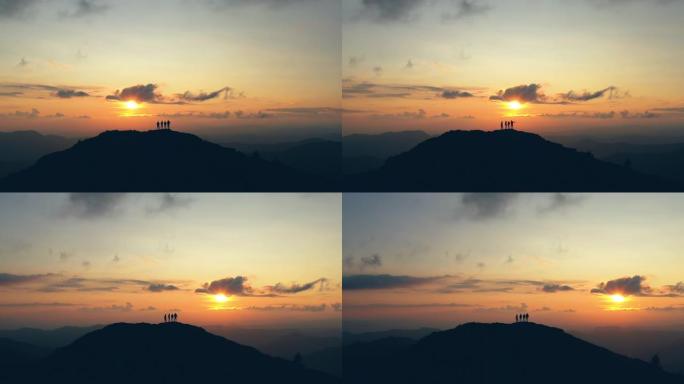 四人在风景如画的夕阳下在山上跳舞