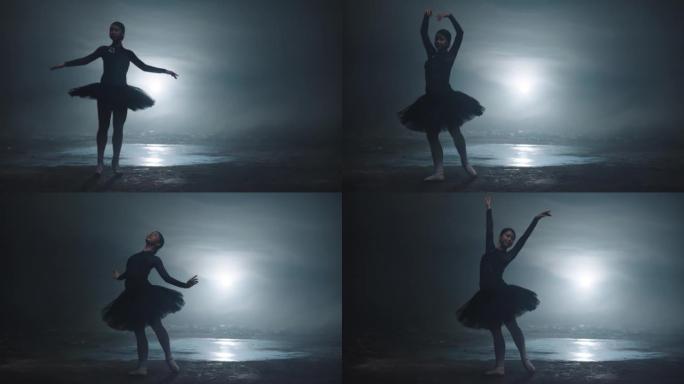 拥有完美身材的年轻迷人芭蕾舞者的剪影在黑暗的灯光下跳舞，背景是光线和烟雾