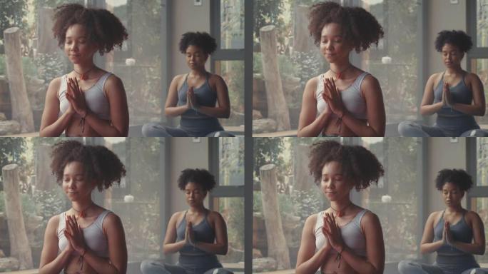 4k视频片段，一名年轻女子在瑜伽课上冥想