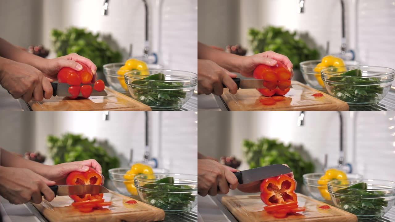 女人的手切番茄女人的手切番茄蔬菜