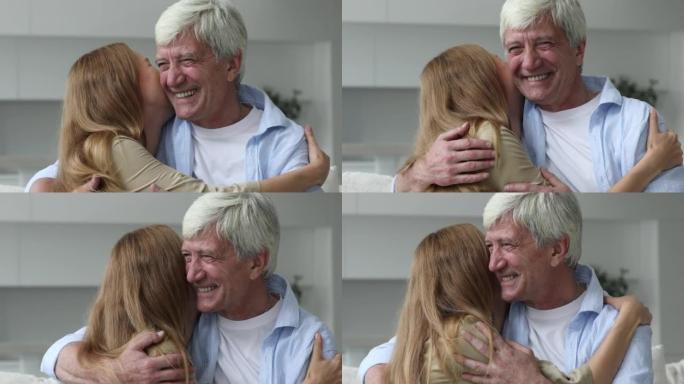 年轻的成年女儿拥抱他年迈的父亲，特写