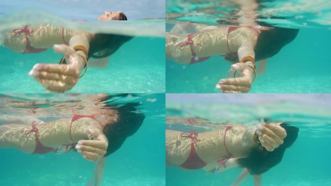 两名迷人的年轻女性在意大利度假期间在海洋中游泳的4k视频片段
