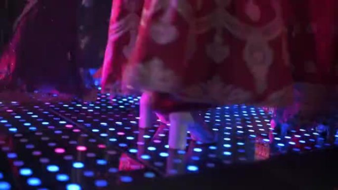 派对发光二极管灯后，低档旁遮普婚礼嘉宾在舞池跳舞