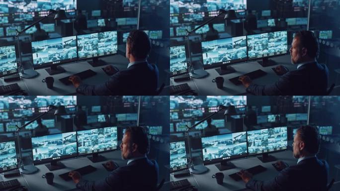男警官在港口监控中心的一台带有监控闭路电视录像的计算机上工作，该中心在大屏幕上有多个摄像头。员工坐在