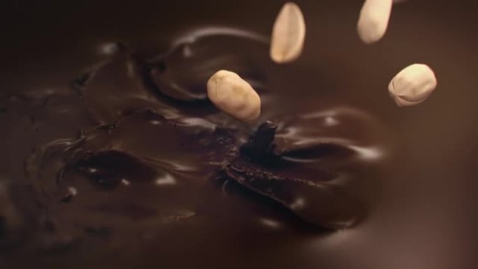 花生在4k超级慢动作中落入液体巧克力中