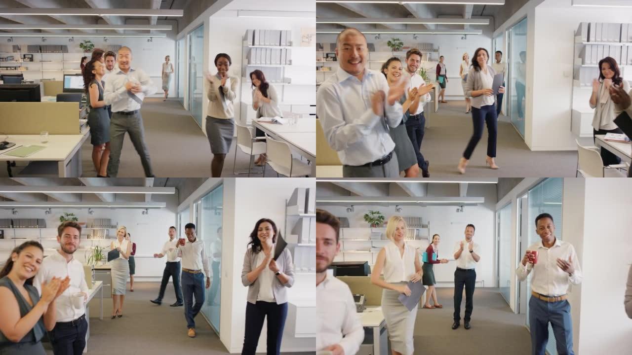 4k视频片段，一群不同的商人在办公室为同事鼓掌