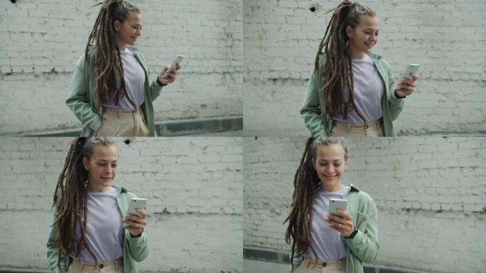 站在外面的智能手机发短信，留着辫子的美丽年轻女子的肖像