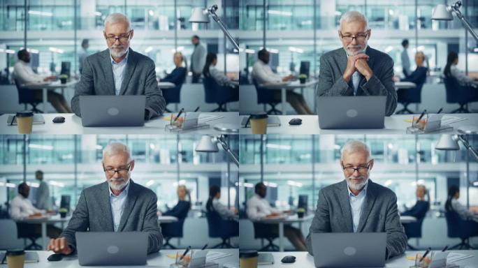 现代办公室: 成功的中年大胡子商人在办公桌前的笔记本电脑上工作的肖像。微笑的企业工人。拥有快乐专业人