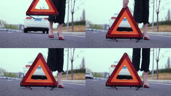 妇女放置红色警告三角形