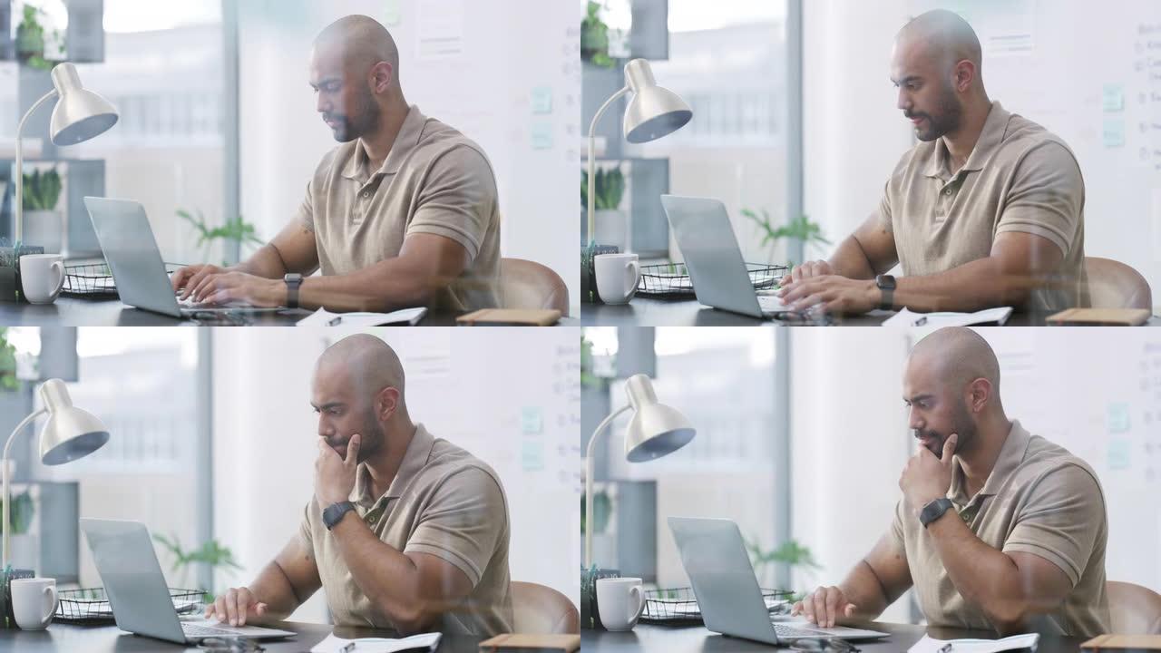 4k视频片段，一个英俊的年轻商人独自坐在办公室里，在使用笔记本电脑时看起来很沉思