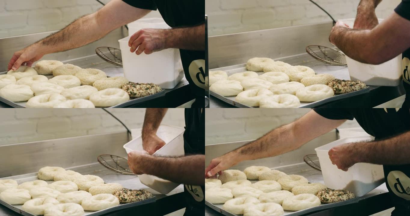 一个无法辨认的面包师在面包店准备百吉饼的4k录像