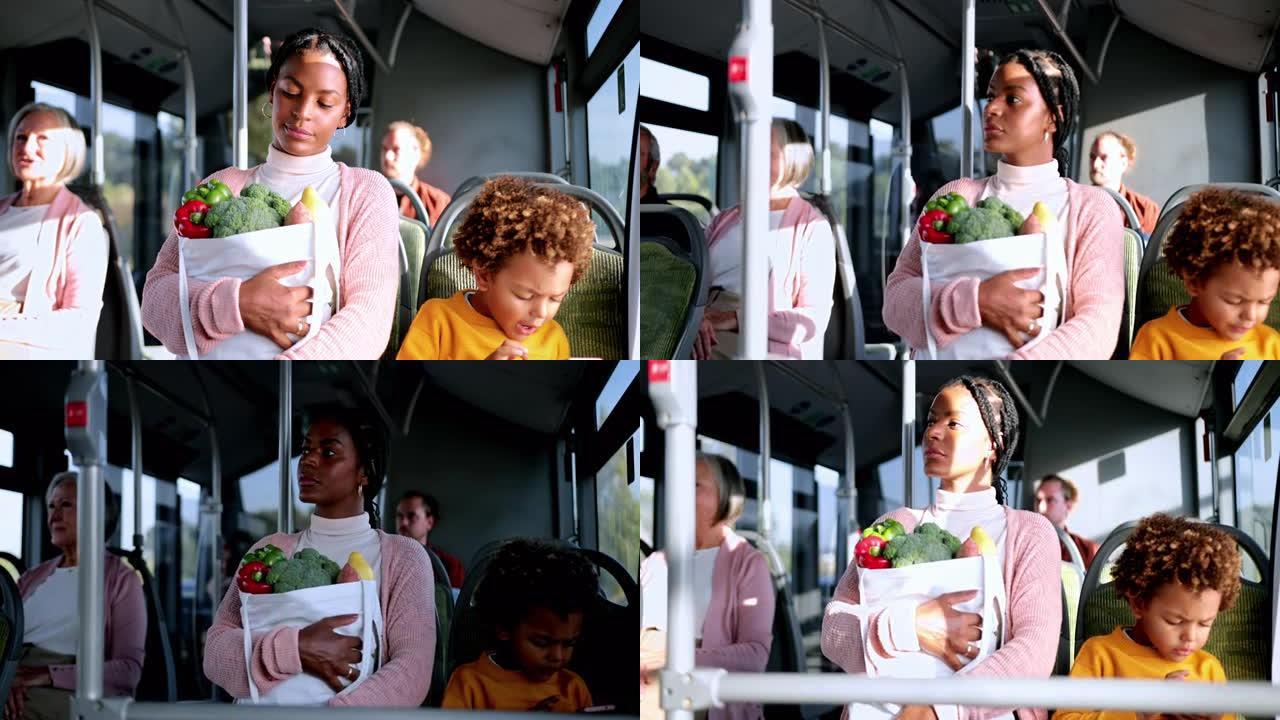 非洲裔美国男孩拿着智能手机，母亲在公共汽车上拿着杂货