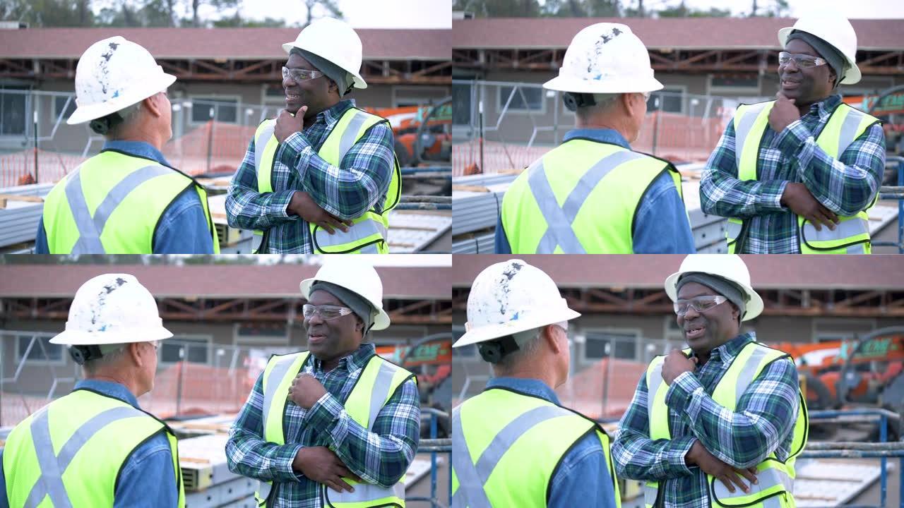 两名多种族建筑工人交谈