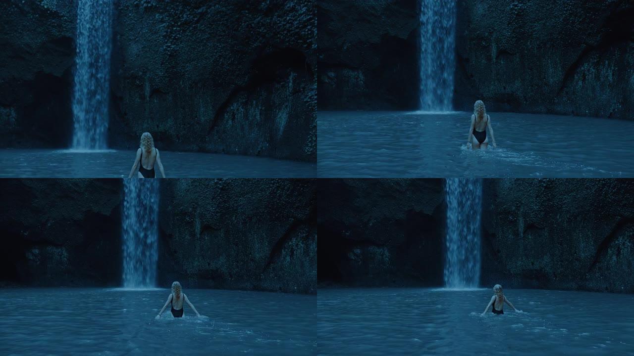 性感的女人漫步在瀑布泳池游泳，穿着泳衣4k享受热带雨林的异国旅行假期