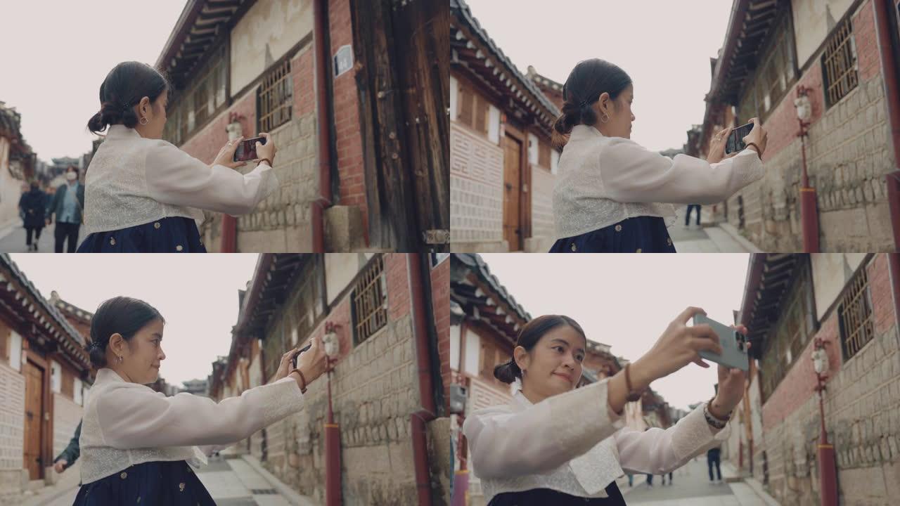 穿着韩服的年轻女子在北村韩屋村开心地自拍。
