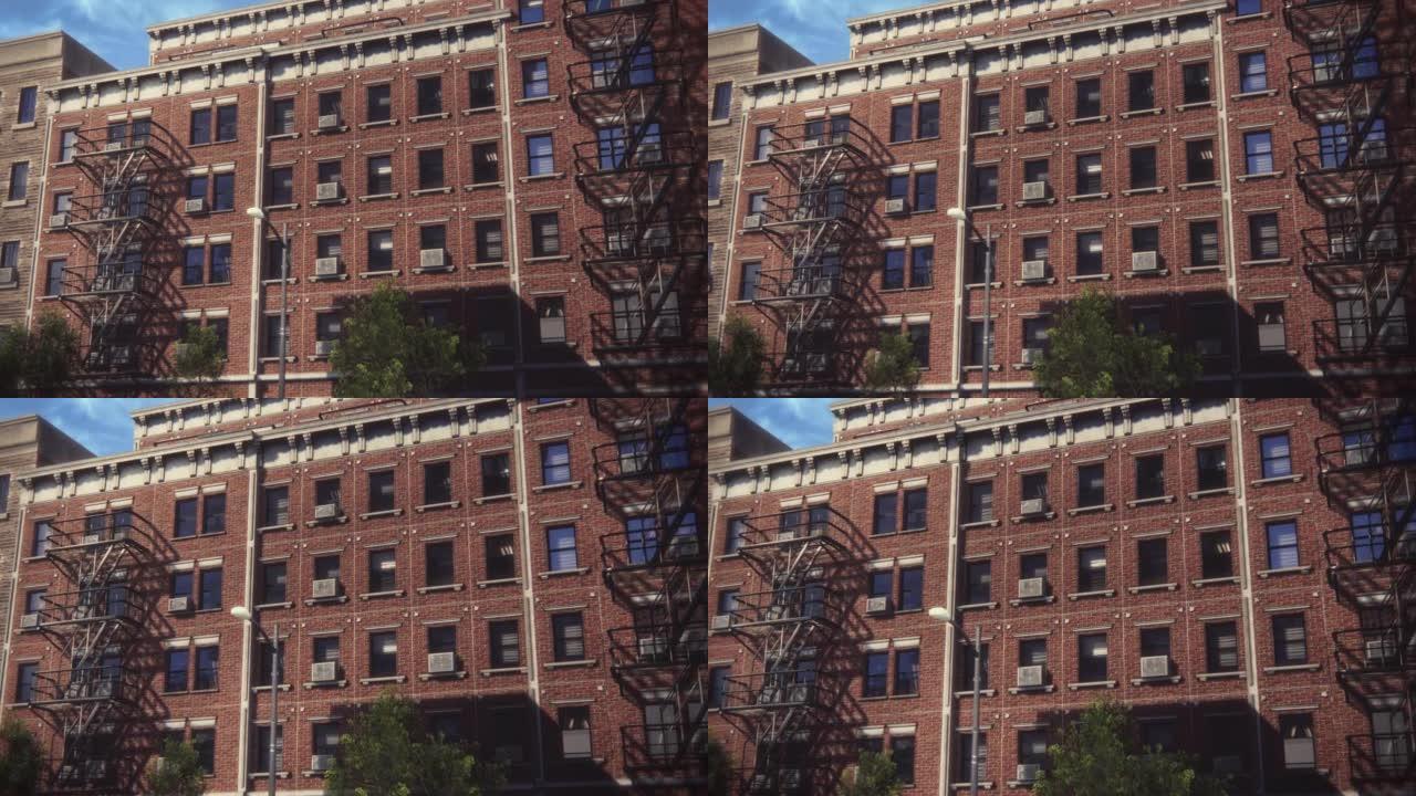 建立者:低角度变焦镜头的VFX动画砖多层公寓楼。翻新的旧褐石屋。有紧急楼梯的住宅白天的城市景观。