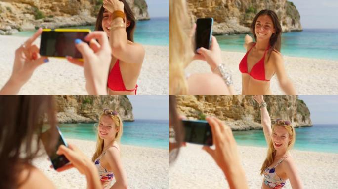 两名年轻女子站在海滩上用手机拍照的4k录像