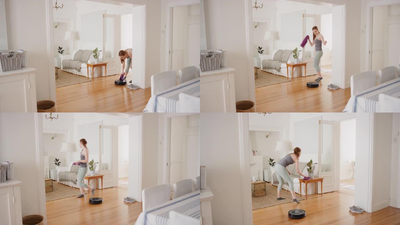 快乐的女人在家跳舞，机器人吸尘器做家务，用有趣的舞蹈庆祝，玩得开心，打扫房子4k