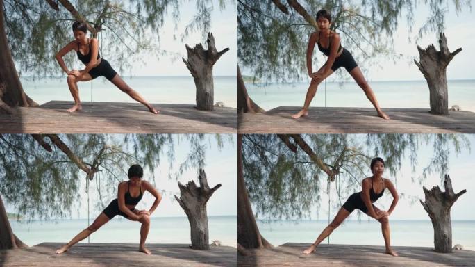 女人在海滩上锻炼瑜伽服女人视频素材户外热