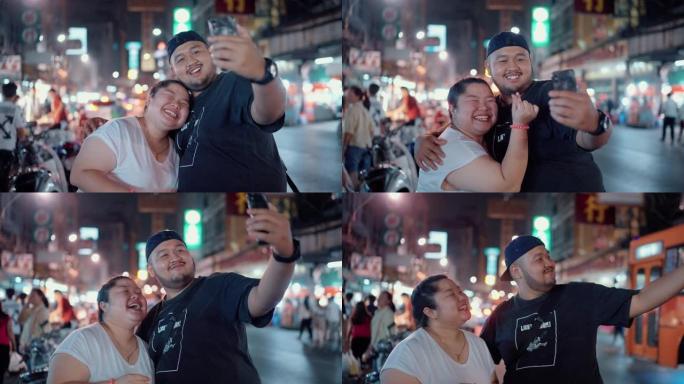 年轻夫妇享受街头美食并在社交媒体上拍照